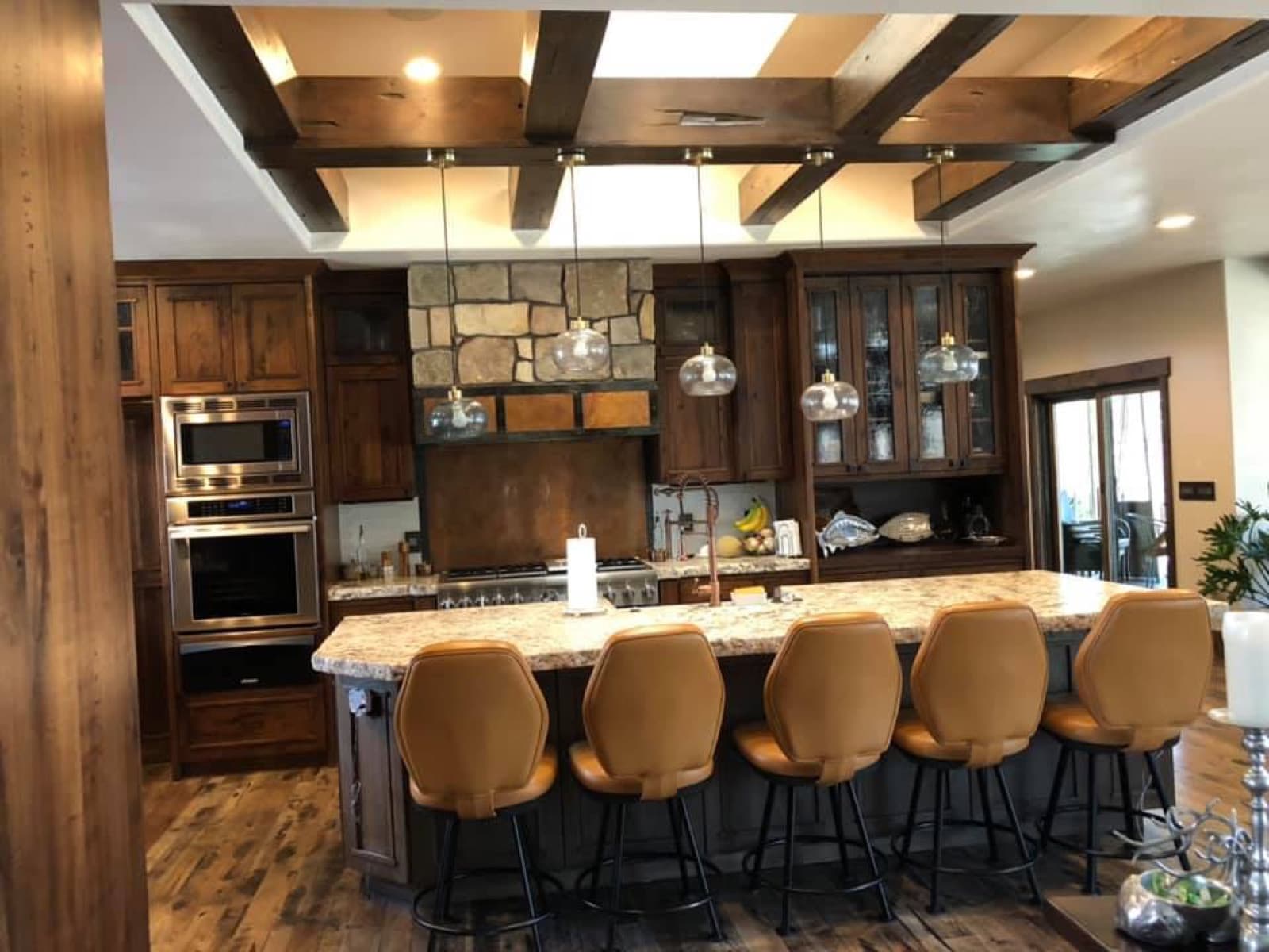Custom dark wood kitchen with a coffered ceiling and island