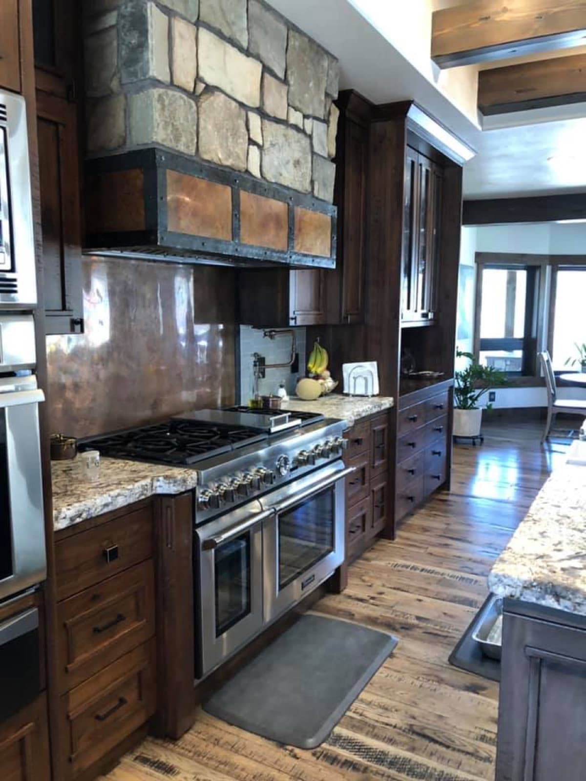 Dark custom kitchen with a professional range